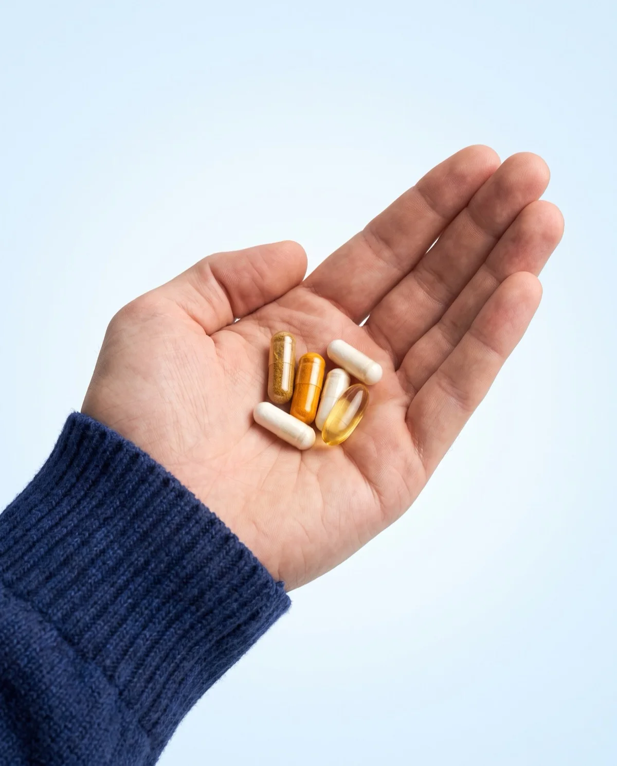 A palm holding Sanazia dietary supplement capsules